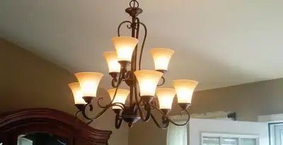 Classic ceiling chandelier installation with warm lighting in Phoenix, AZ
