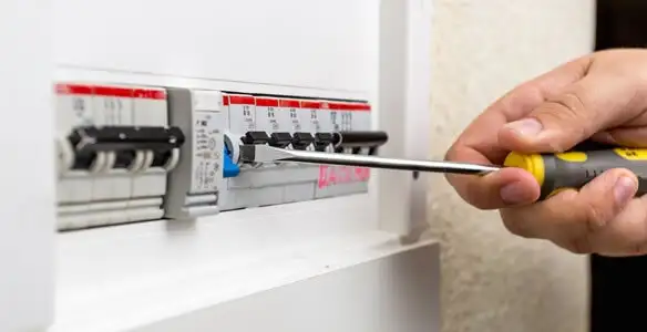 electrical panel upgrade service showing technician adjusting circuit breakers during system upgrade in Phoenix, AZ