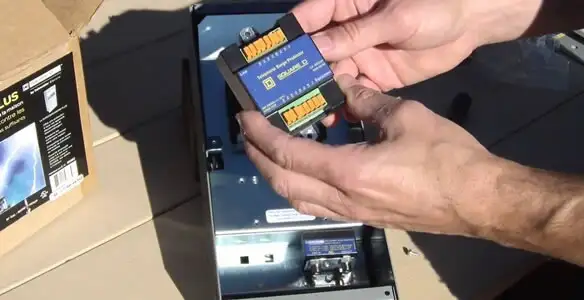 Electrician installing whole home surge protection unit inside main electrical panel in Phoenix, AZ