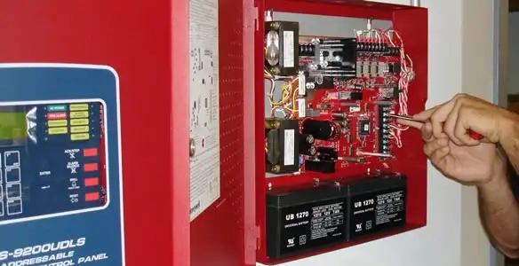 fire alarm installation service showing technician configuring fire alarm control panel in Phoenix, AZ