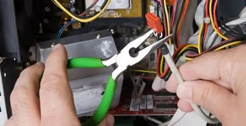 Licensed electrical contractor performing electrical repair with tools in Scottsdale, AZ