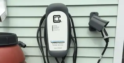 Outdoor electric vehicle charger installation on residential wall in Phoenix, AZ