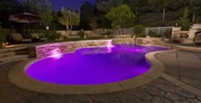pool light installation and repair services illuminating a residential swimming pool in Phoenix, AZ