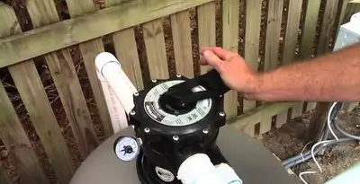pool pumps service showing professional adjustment of pool pump control system in Phoenix, AZ