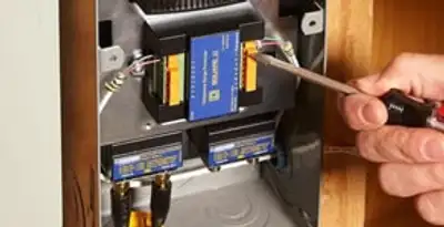 Whole home surge protection device being installed by a licensed electrician to protect electrical systems in Phoenix, AZ